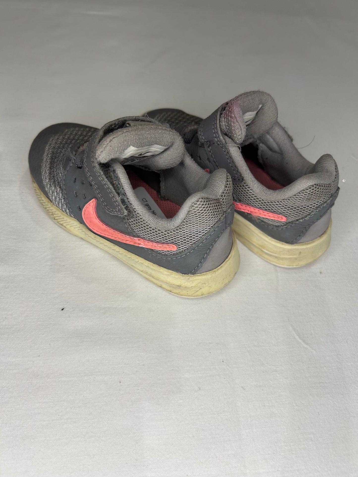 C7 grey Nikes pink swoosh